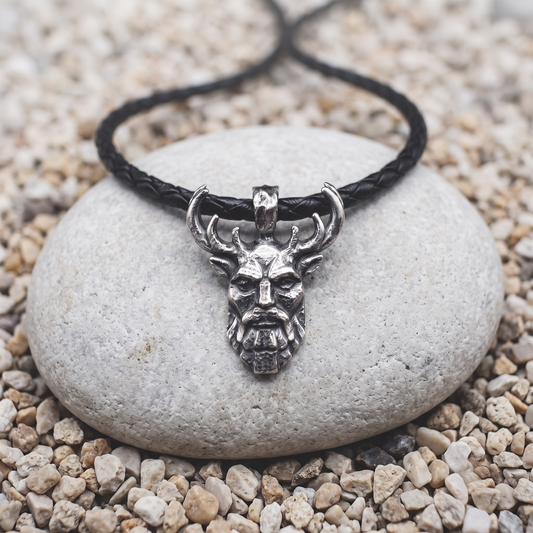 Herne necklace in .999 fine silver — a bearded antlered face, oxidized deep, on a black braided leather cord