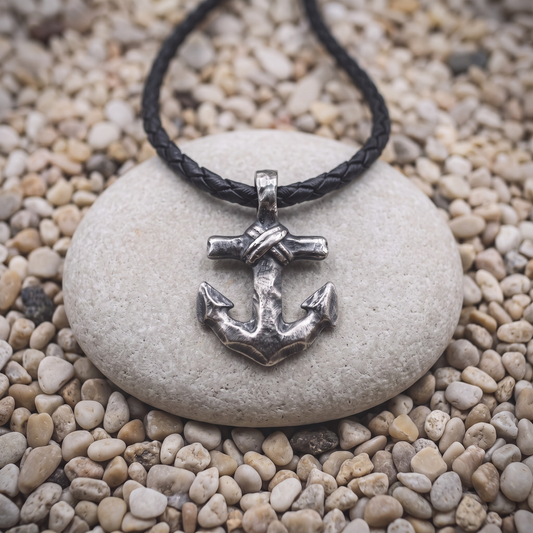 The Anchor necklace in .999 fine silver — an anchor with rope wound and knotted at the crossbar, on a black braided leather cord