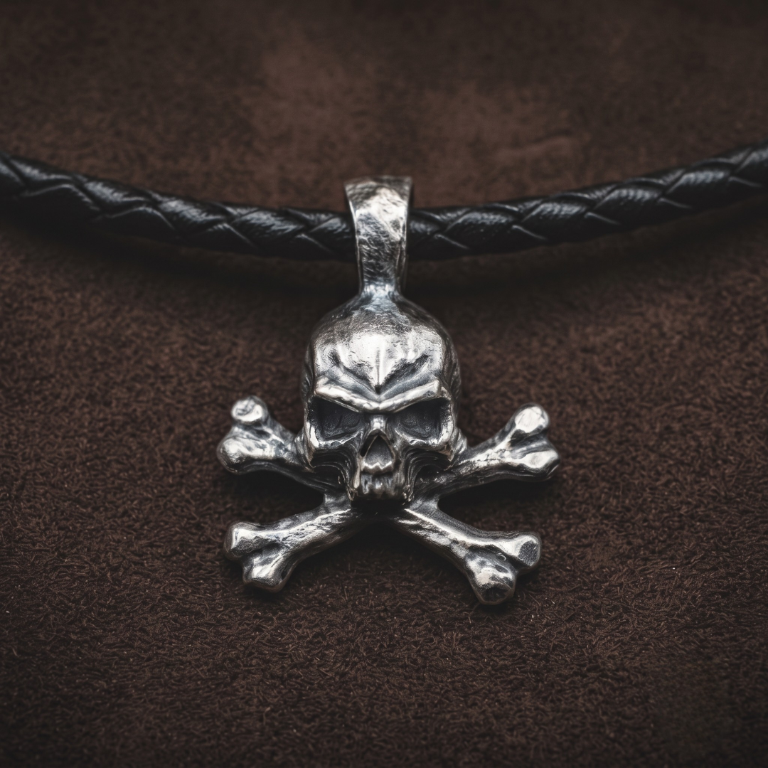 No Master — hand-poured skull and crossbones pendant in oxidized .999 fine silver on a black braided leather cord